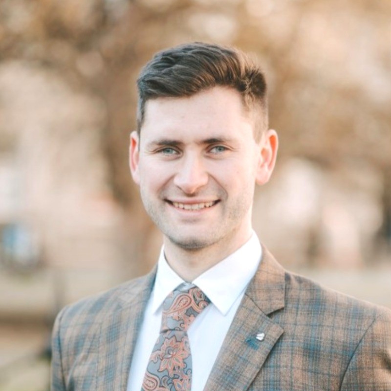 Oisín Bridges, founder of DataBridges, wearing a tweed jacket and paisley tie